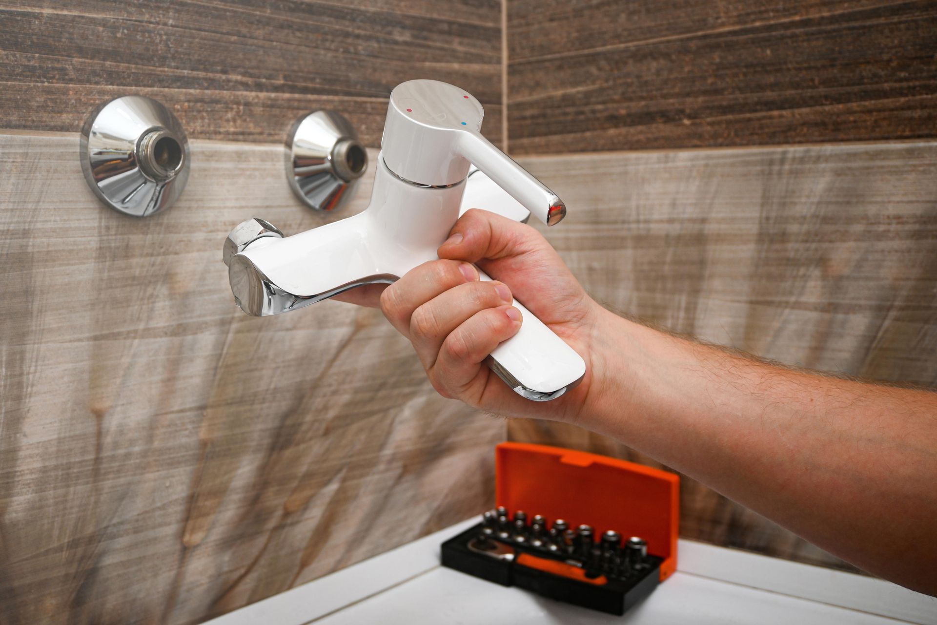 A white and chrome shower faucet
