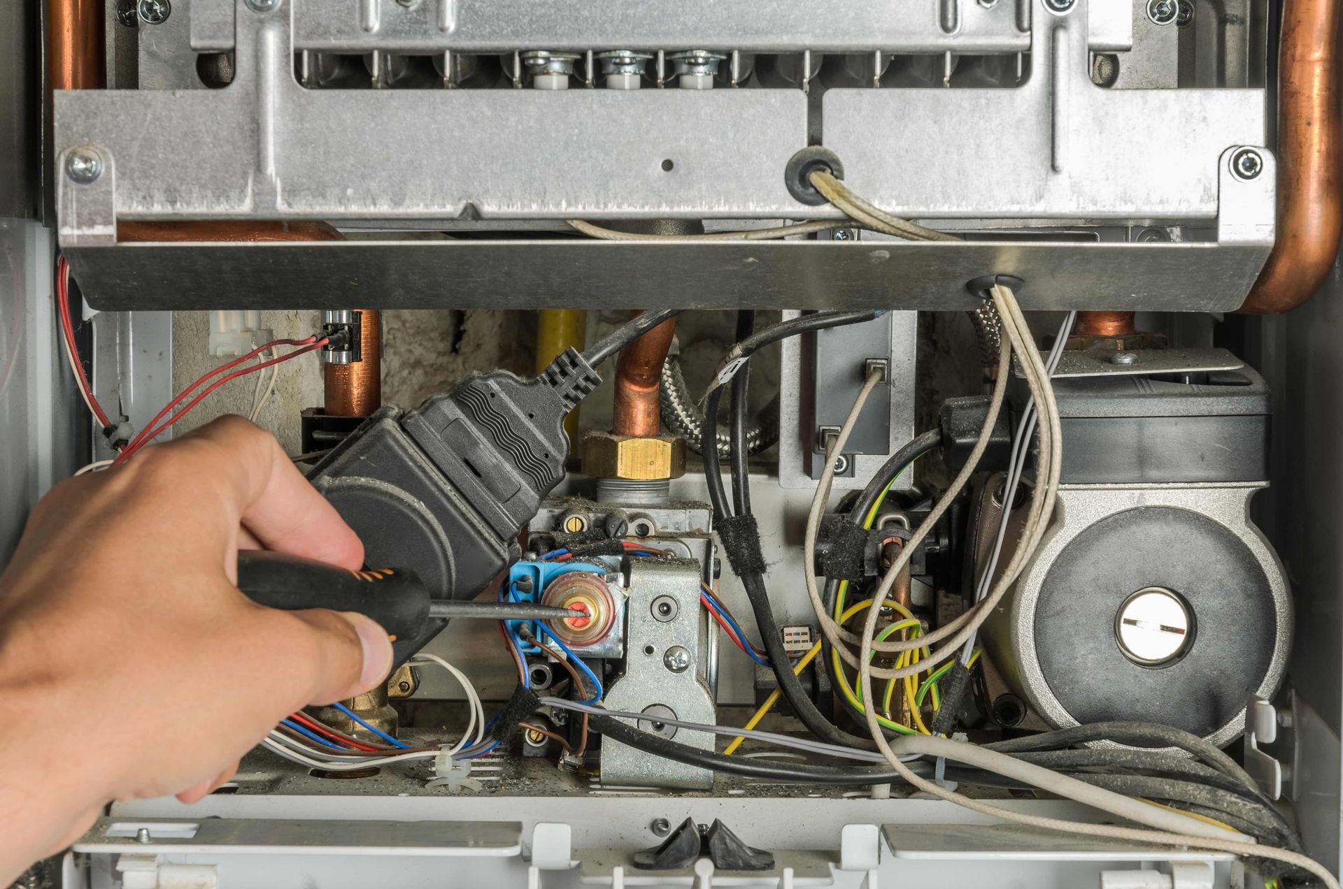 A technician repairing a water heater